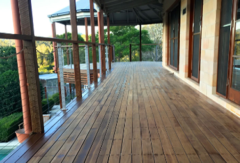 A weathered, faded Kwila timber deck before restoration