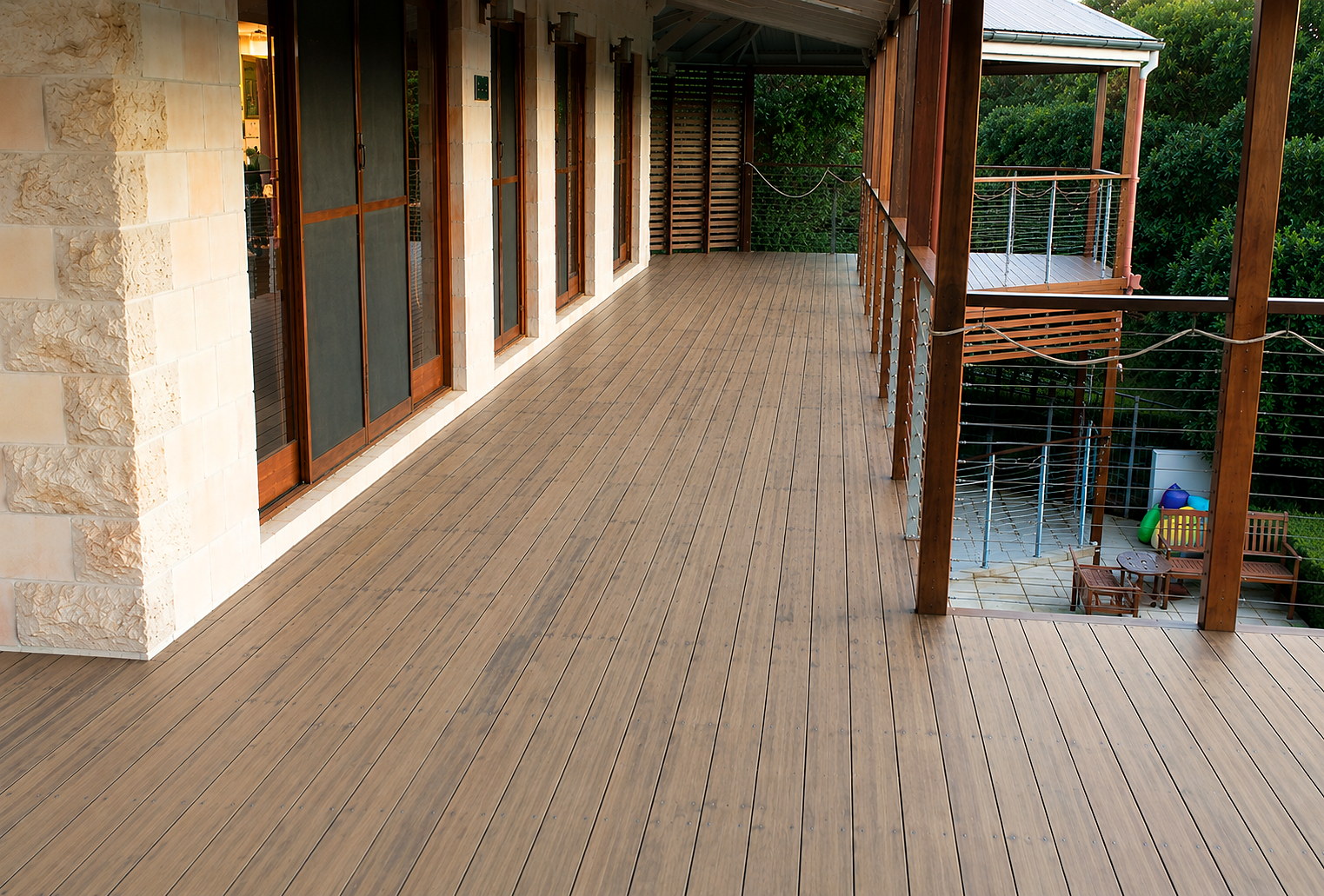A weathered, faded Kwila timber deck before restoration